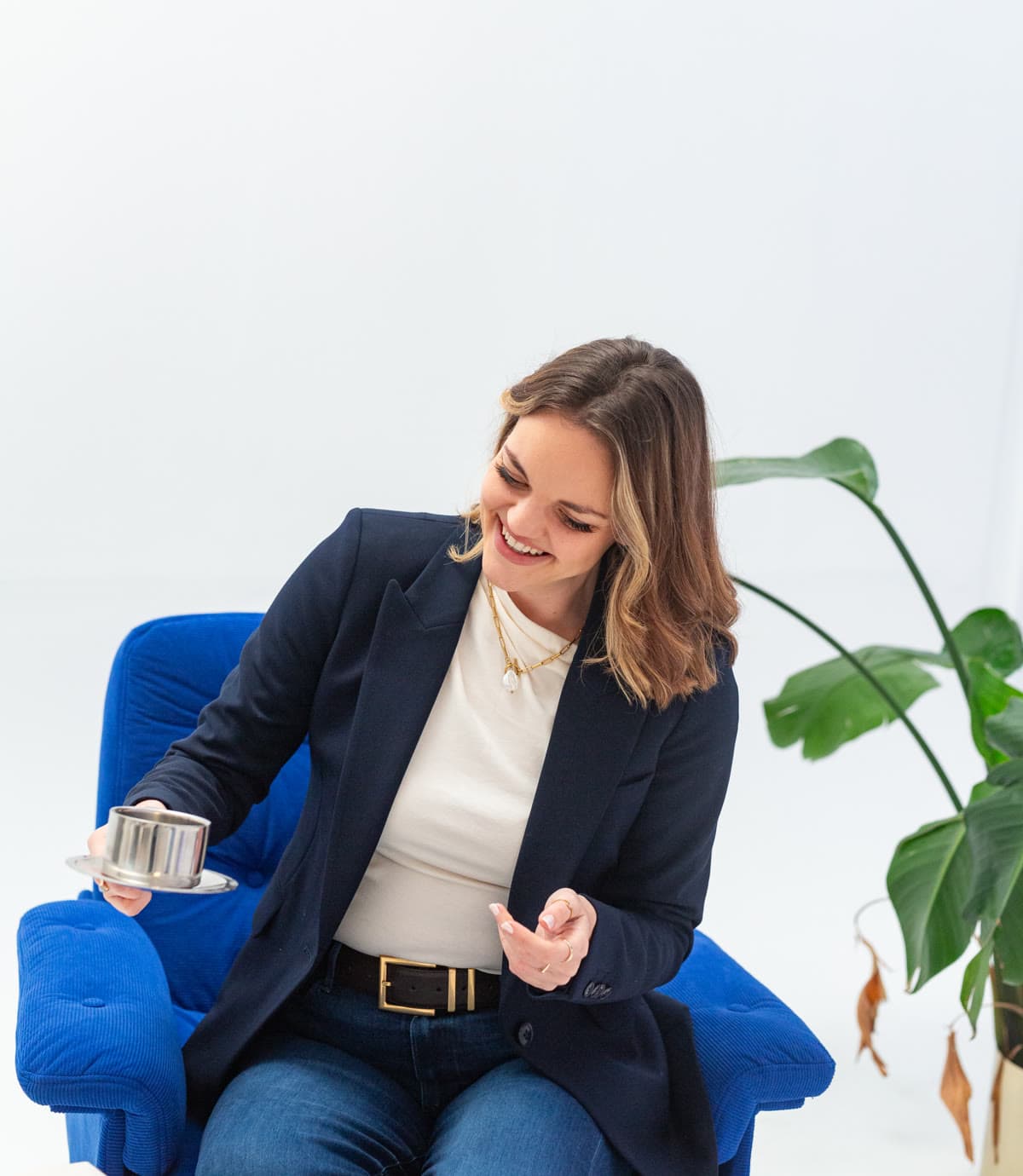 Kirsty Hulse laughing in a blue armchair