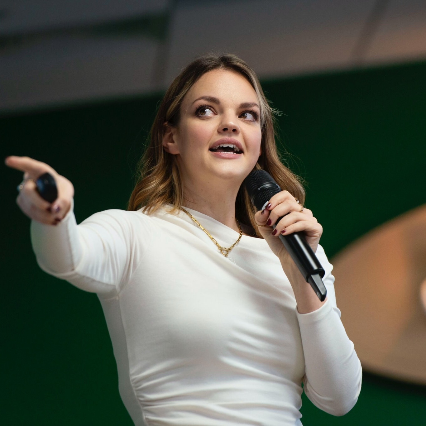 Kirsty Hulse speaking on stage with a microphone